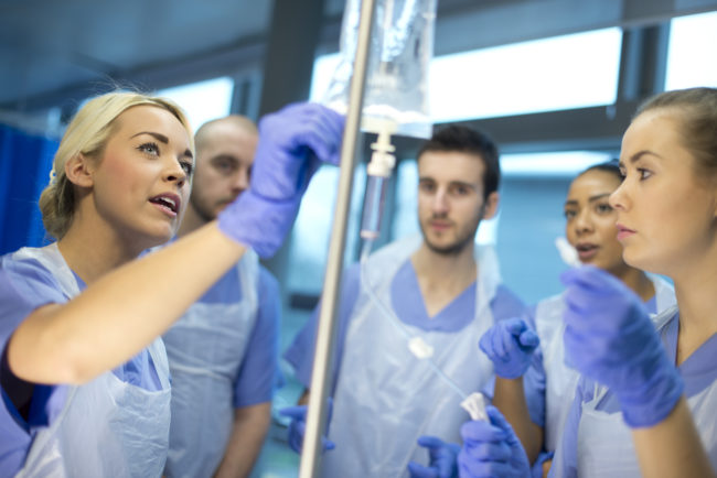 nurse shows other trainees how to use the IV drip