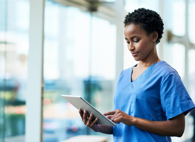 Shot of a young medical practitioner using a digital tablet in a hospital