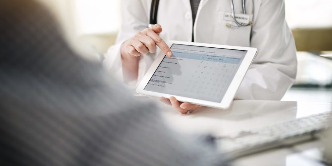 Shot of a doctor showing a senior patient some information on a digital tablet in her office