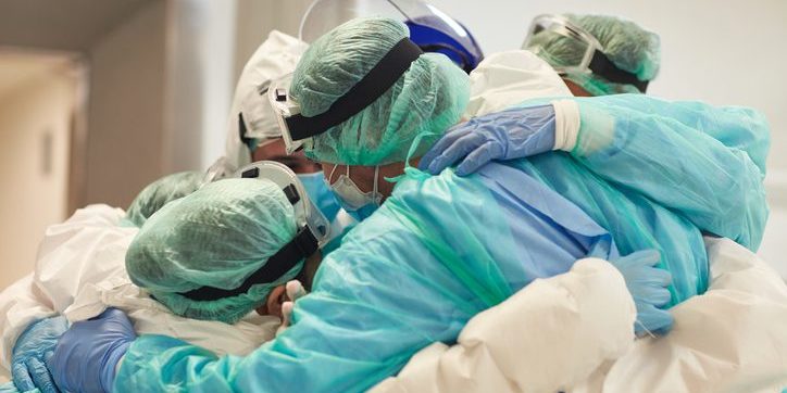 Doctors and Nurses With Arms Around Each Other in Support