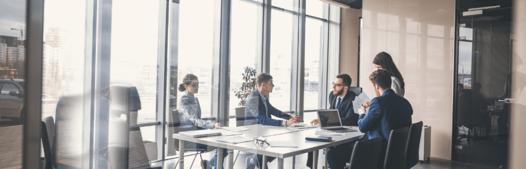 business men and women in a conference room to meet