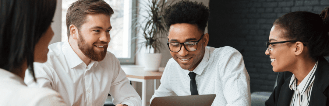 young coworkers smiling while in a meeting