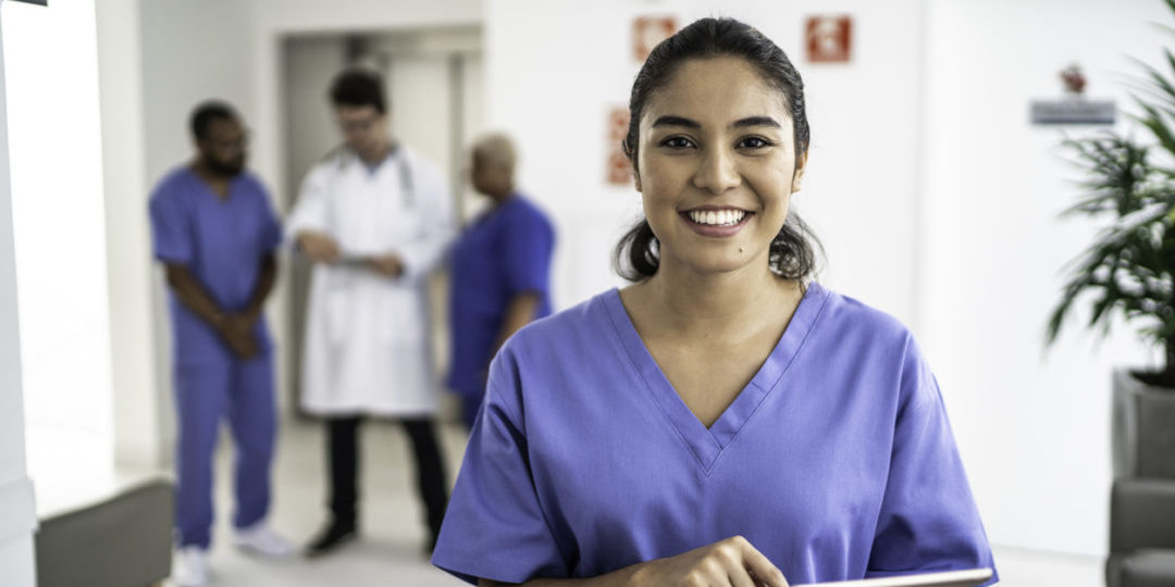 Portrait of female nurse using tablet at hospital