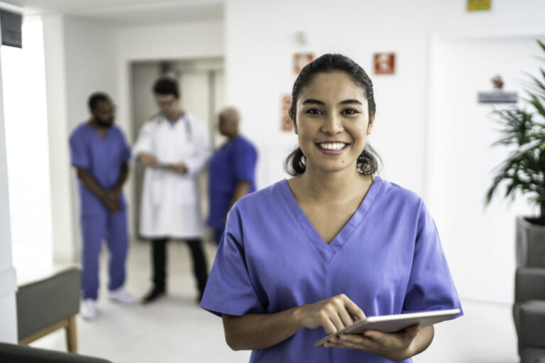 Portrait of female nurse using tablet at hospital