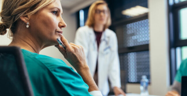 Female medical professional in staff meeting