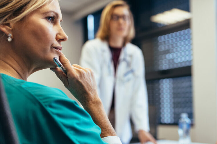 Female medical professional in staff meeting