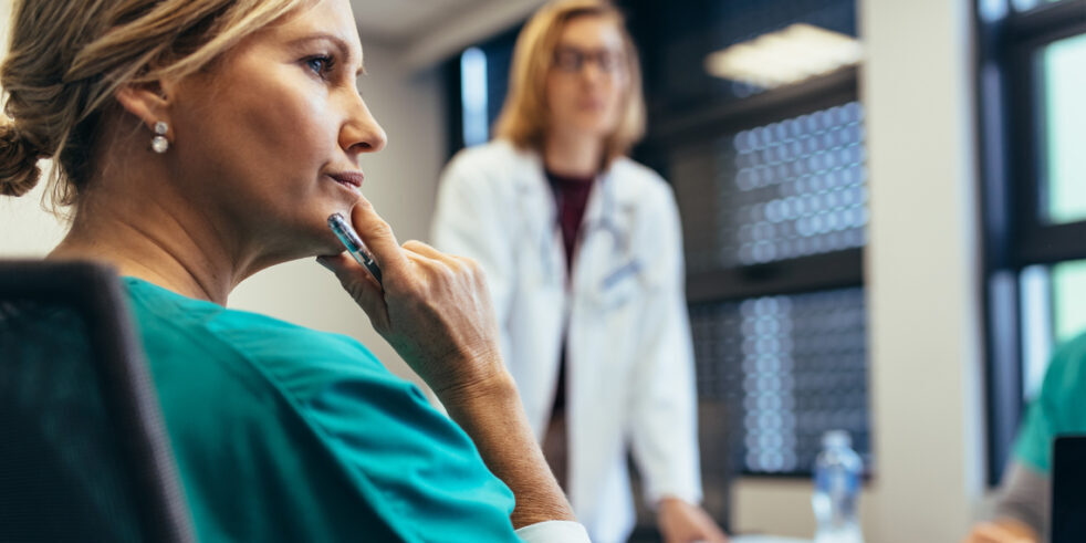 Female medical professional in staff meeting